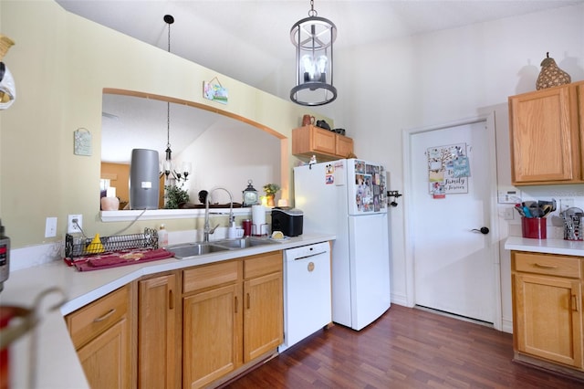 kitchen with white appliances, decorative light fixtures, and a notable chandelier