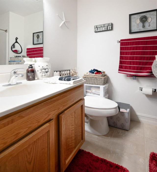 bathroom featuring tile patterned flooring, vanity, and toilet