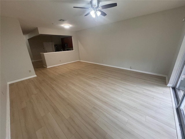 unfurnished living room featuring ceiling fan and light hardwood / wood-style flooring