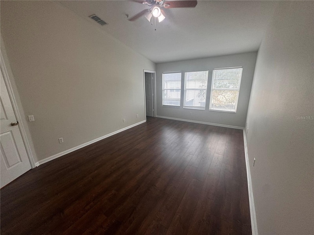 empty room featuring ceiling fan and dark hardwood / wood-style flooring