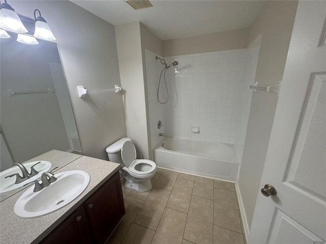 full bathroom with tile patterned floors, vanity, toilet, and tiled shower / bath combo