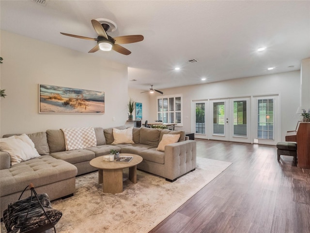 living room with hardwood / wood-style flooring and ceiling fan