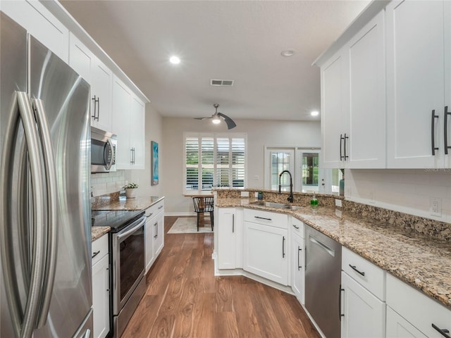 kitchen featuring appliances with stainless steel finishes, ceiling fan, sink, white cabinets, and dark hardwood / wood-style floors