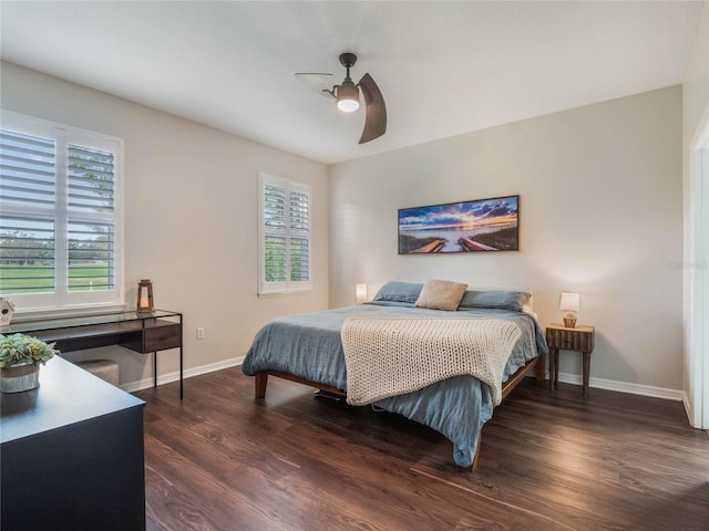 bedroom with ceiling fan, dark hardwood / wood-style floors, and multiple windows