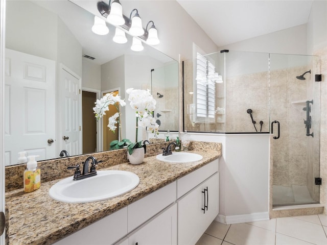 bathroom featuring tile patterned floors, vanity, and a shower with shower door