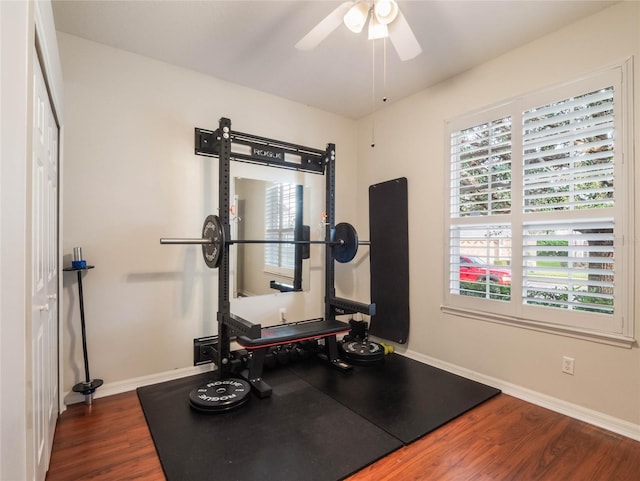 workout area with ceiling fan and dark wood-type flooring