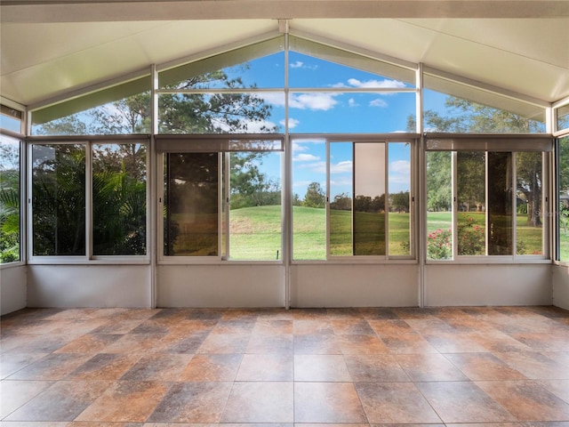 unfurnished sunroom with plenty of natural light and vaulted ceiling