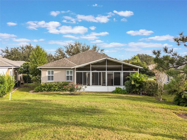 back of property featuring a yard and a sunroom