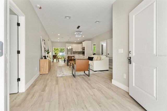 205 E 17th St, Apopka, FL 32703 - living room featuring light wood-style flooring and baseboards