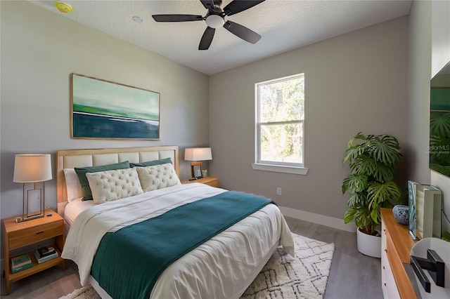 205 E 17th St, Apopka, FL 32703 - bedroom with wood finished floors, baseboards, and a ceiling fan