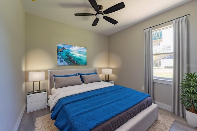 205 E 17th St, Apopka, FL 32703 - bedroom with multiple windows, baseboards, wood finished floors, and ceiling fan