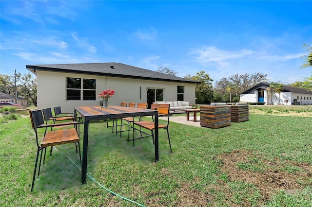 205 E 17th St, Apopka, FL 32703 - rear view of house with an outdoor hangout area, stucco siding, and a yard