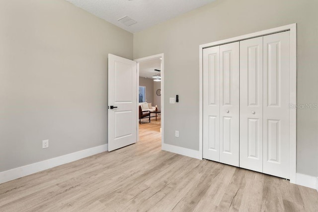 205 E 17th St, Apopka, FL 32703 - unfurnished bedroom featuring light wood-type flooring, a closet, and baseboards