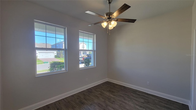 spare room with ceiling fan and dark wood-type flooring