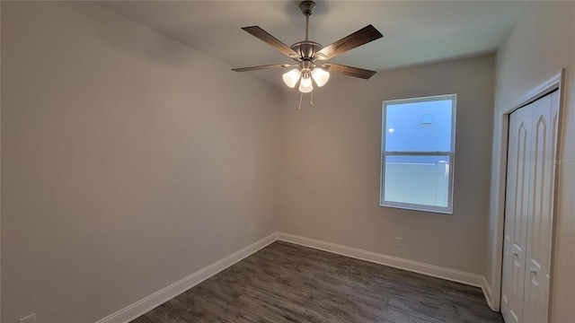 unfurnished room with ceiling fan and dark wood-type flooring