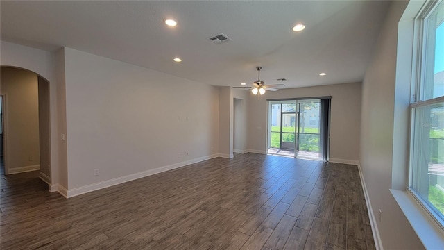 empty room featuring ceiling fan and dark wood-type flooring