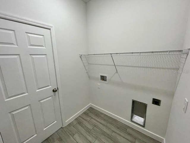 clothes washing area featuring hardwood / wood-style flooring, washer hookup, and hookup for an electric dryer