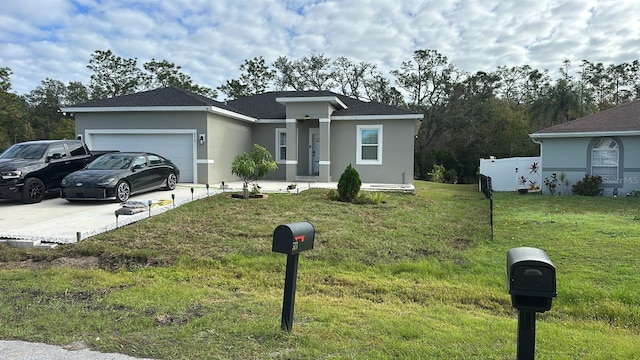 view of front of home featuring a front yard and a garage