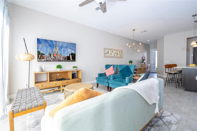 living room featuring ceiling fan with notable chandelier