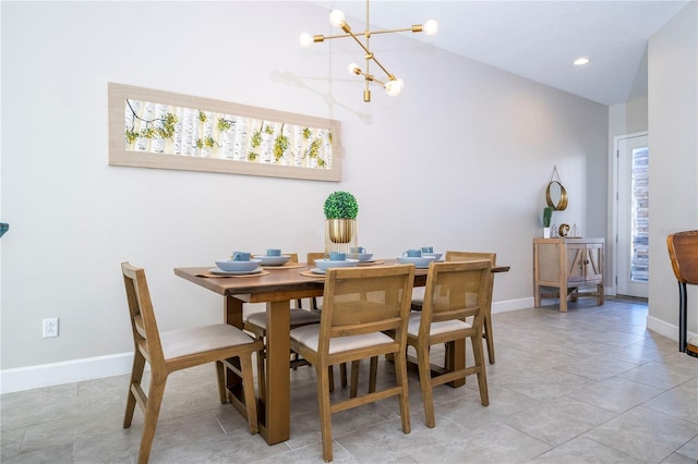 tiled dining space featuring high vaulted ceiling and an inviting chandelier