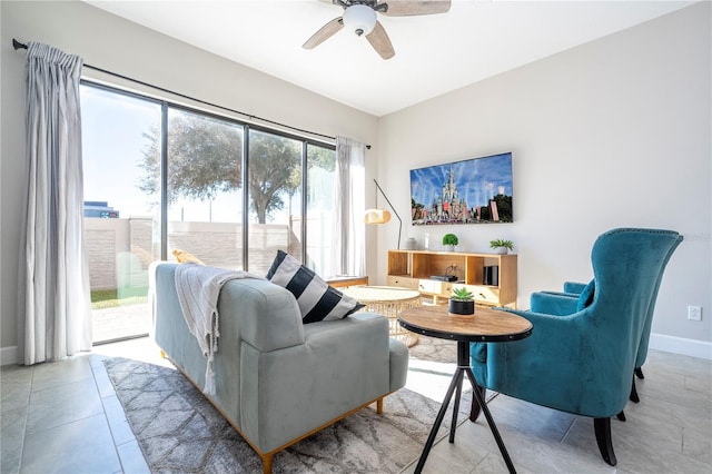 living room with ceiling fan and light tile patterned flooring