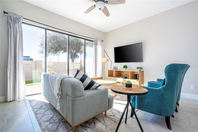 living room with ceiling fan, light tile patterned flooring, and a healthy amount of sunlight