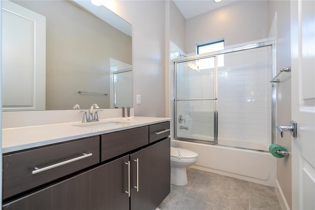 full bathroom featuring tile patterned flooring, combined bath / shower with glass door, toilet, and vanity