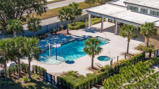 view of swimming pool featuring a community hot tub and a patio