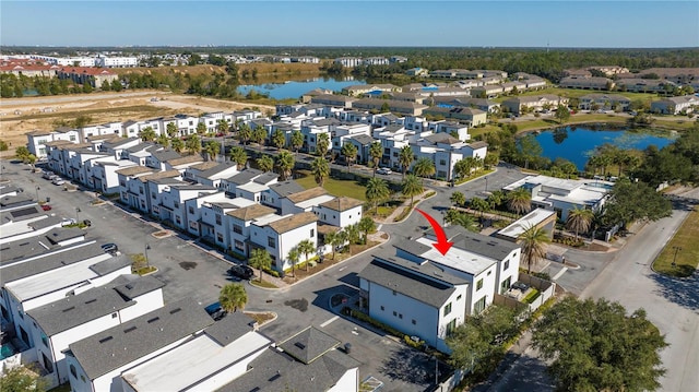 birds eye view of property with a water view