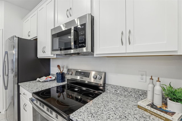 1708 Columbus Path, Saint Cloud, FL 34771 - kitchen with stainless steel appliances, white cabinetry, and light stone counters