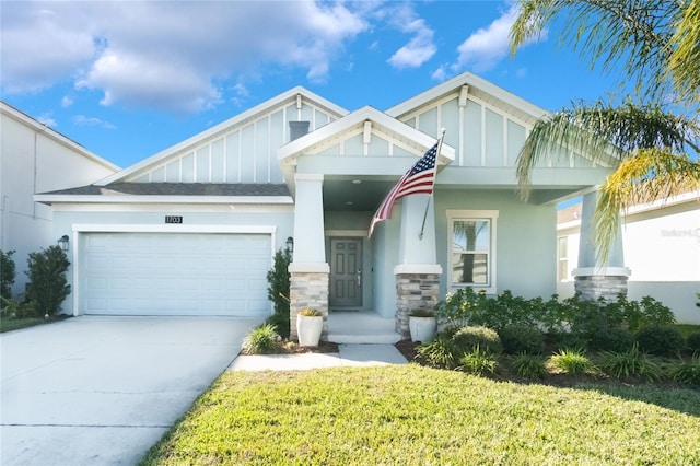 craftsman house featuring a front yard and a garage