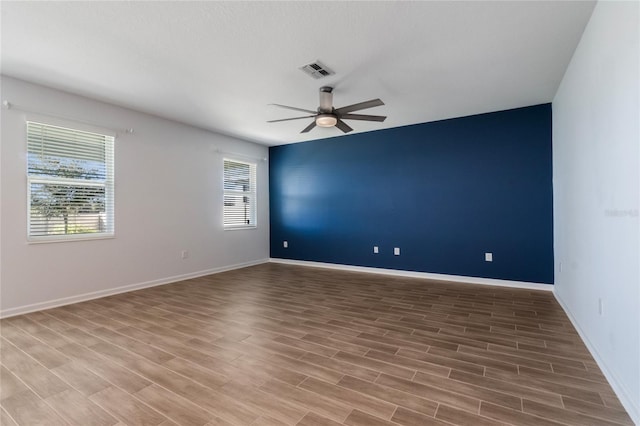 unfurnished room featuring ceiling fan and wood-type flooring