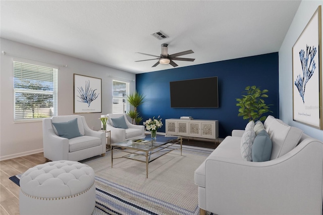 living room with ceiling fan and light wood-type flooring