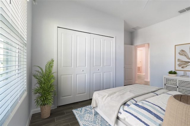 bedroom featuring dark hardwood / wood-style flooring and a closet