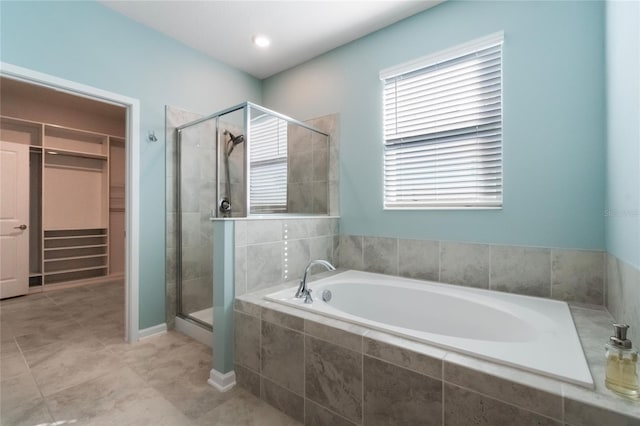 bathroom featuring tile patterned floors and independent shower and bath