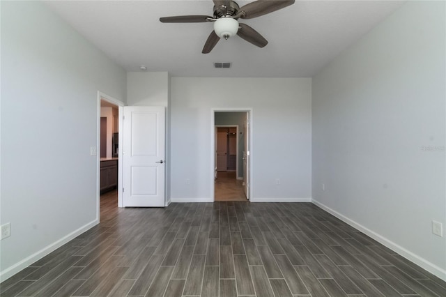 unfurnished bedroom with ceiling fan and dark wood-type flooring