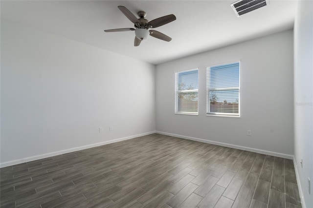 spare room with ceiling fan and dark wood-type flooring