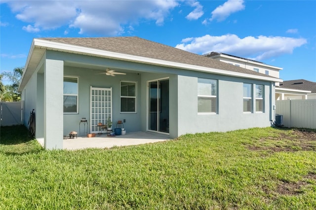 back of property with a lawn, ceiling fan, a patio area, and central AC