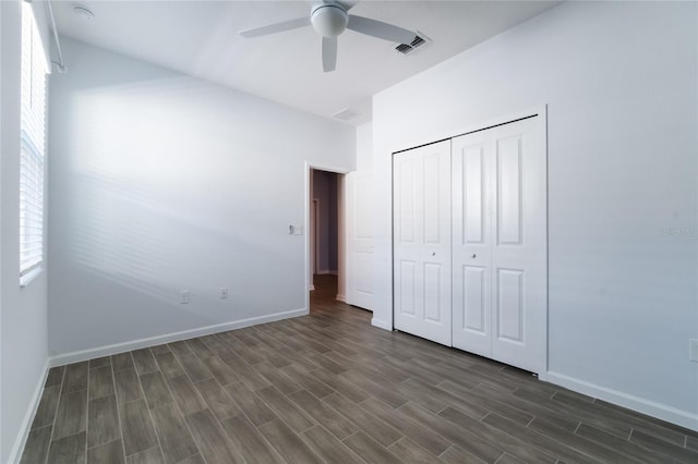 unfurnished bedroom featuring a closet, dark hardwood / wood-style floors, and ceiling fan