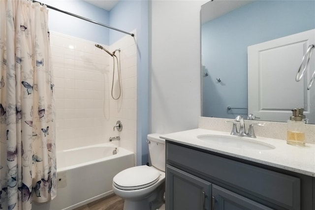 full bathroom featuring hardwood / wood-style flooring, vanity, toilet, and shower / bathtub combination with curtain