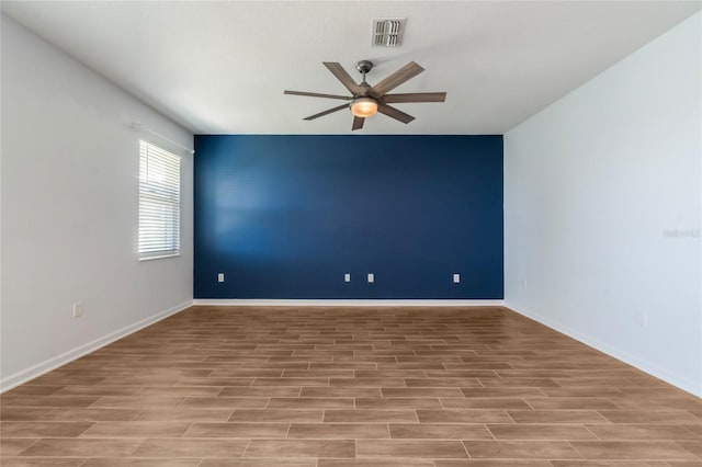 spare room with ceiling fan and light hardwood / wood-style flooring