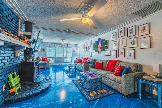 living room featuring a wood stove, concrete floors, a textured ceiling, and ornamental molding