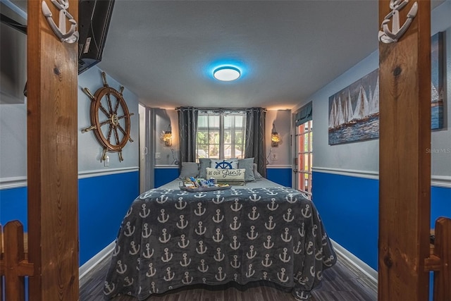 bedroom featuring hardwood / wood-style floors and a textured ceiling