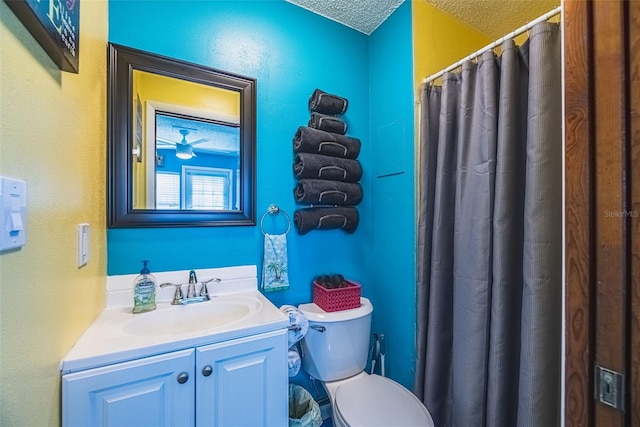 bathroom featuring vanity, a textured ceiling, toilet, and curtained shower