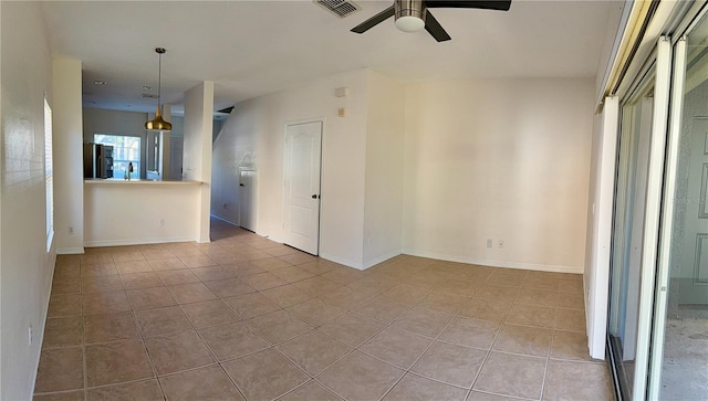 interior space with ceiling fan