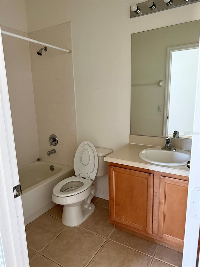 full bathroom featuring tile patterned flooring, tiled shower / bath combo, toilet, and vanity