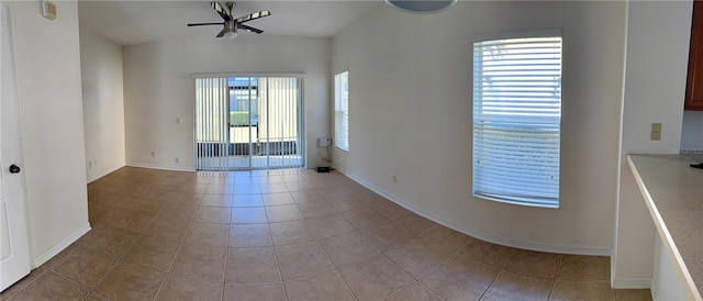 tiled spare room featuring ceiling fan and plenty of natural light