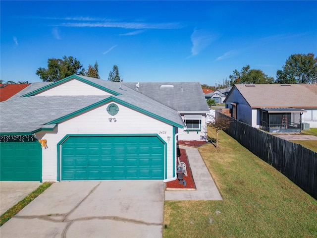 single story home with central AC unit, a garage, and a front lawn