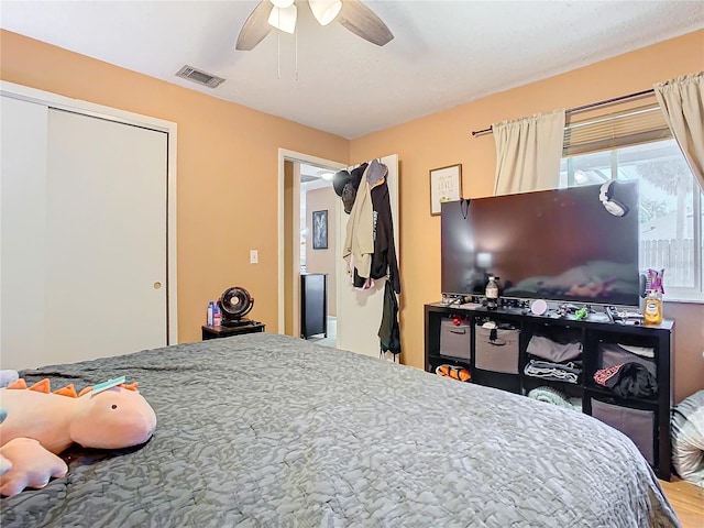 bedroom featuring ceiling fan and a closet