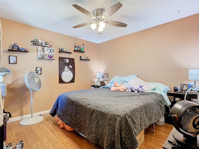 bedroom with hardwood / wood-style floors and ceiling fan